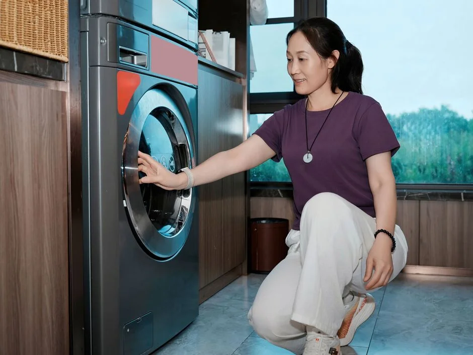 Distilled white vinegar bottle next to a washing machine