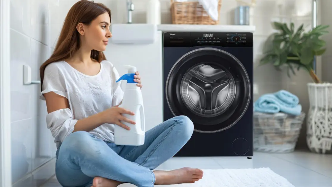 Washing machine drum with clothes and fabric softener being added